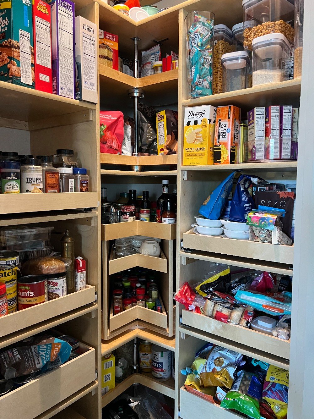 Corner solutions and glide out shelves in an L shaped pantry