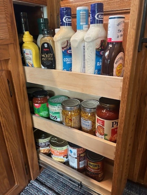 This customer has a small cabinet that was useless wasted space. We put 3 glide outs in this tiny cabinet and attached the cabinet door to the glide outs. Now she can pull it out and use that previously wasted space. She is so happy to be able to not waste anything in this small kitchen.