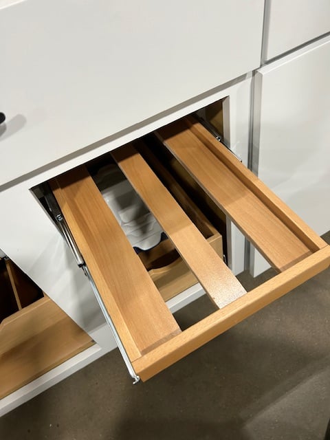 Here is our solution for your wine bottles. They are custom made to fit into your space and you can lay your bottle flat.  This way you can see what you want and what you have.