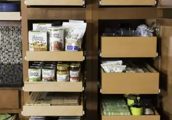 Kitchen with cabinets open to reveal shelving by ShelfGenie.