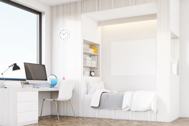 A room with a desk and a bed.