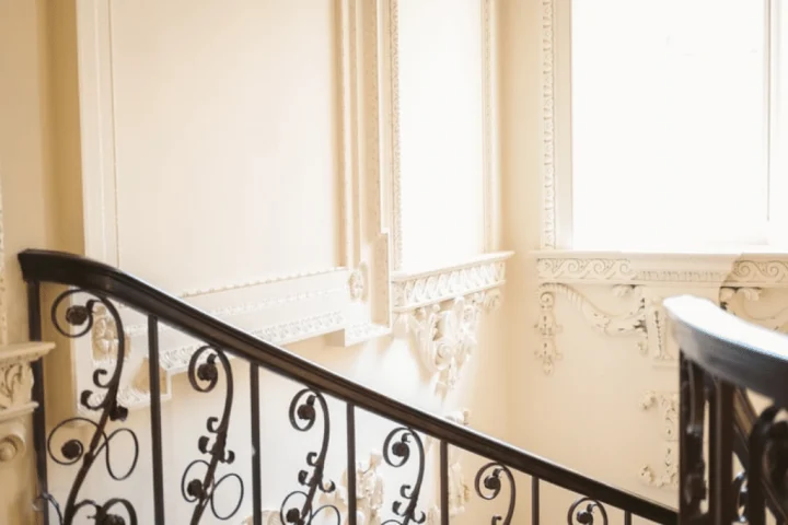 A staircase with a black railing.