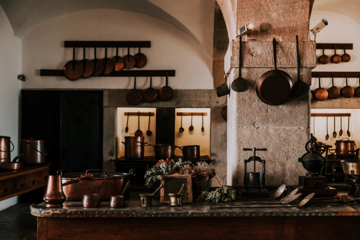 Vintage look kitchen with hanging rods for pots and pans.