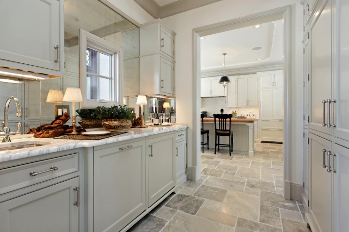 A kitchen with white cabinets and a countertop.