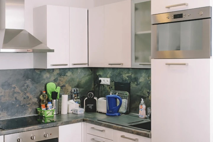 white wooden kitchen cabinet with blue and white electric kettle.